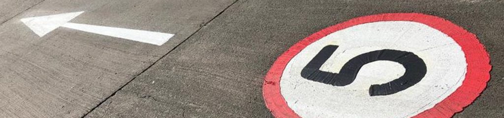 Line-Marking-header very close up shot of 5 MPH sign painted into warehouse floor