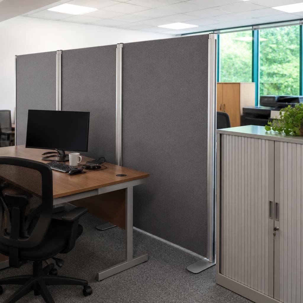 Freestanding office divider panels positioned between existing desks and cabinets